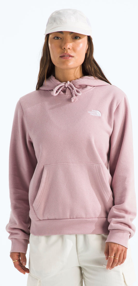 A person wearing a pink hoodie and a white cap.