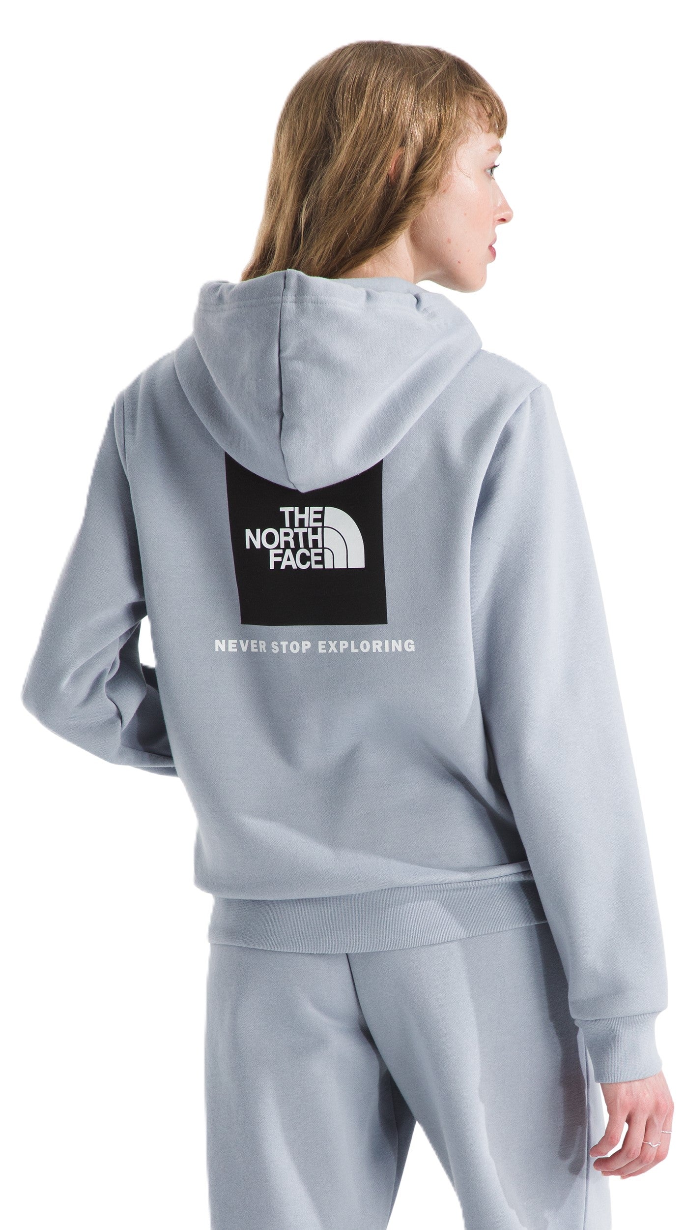 Light blue hooded sweatshirt with a black rectangle with THE NORTH FACE logo and NEVER STOP EXPLORING text.