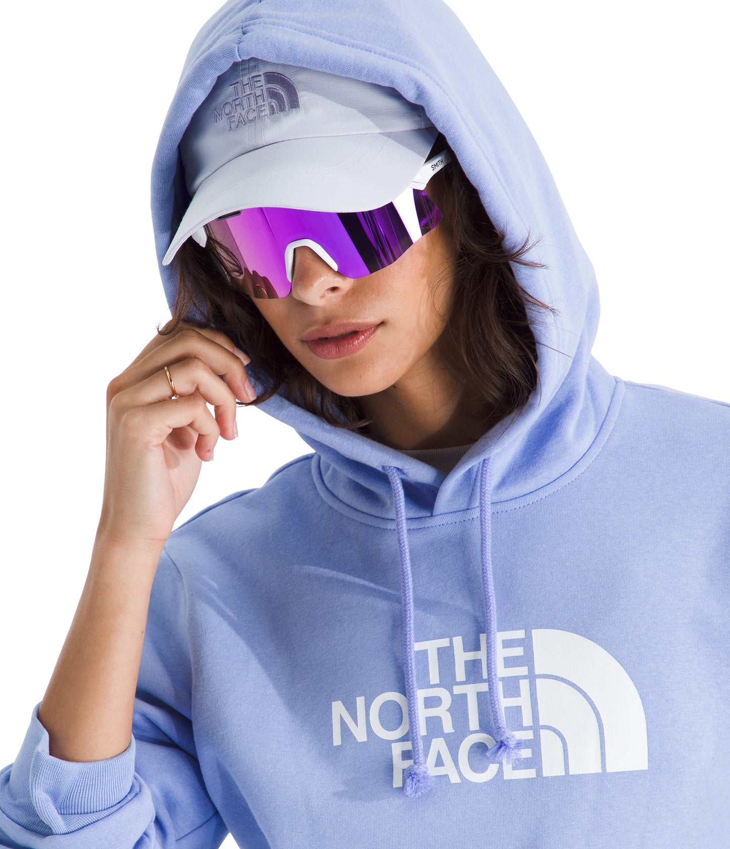 Person wearing a light purple hoodie with "THE NORTH FACE" printed on it, light gray hat, and futuristic purple sunglasses.