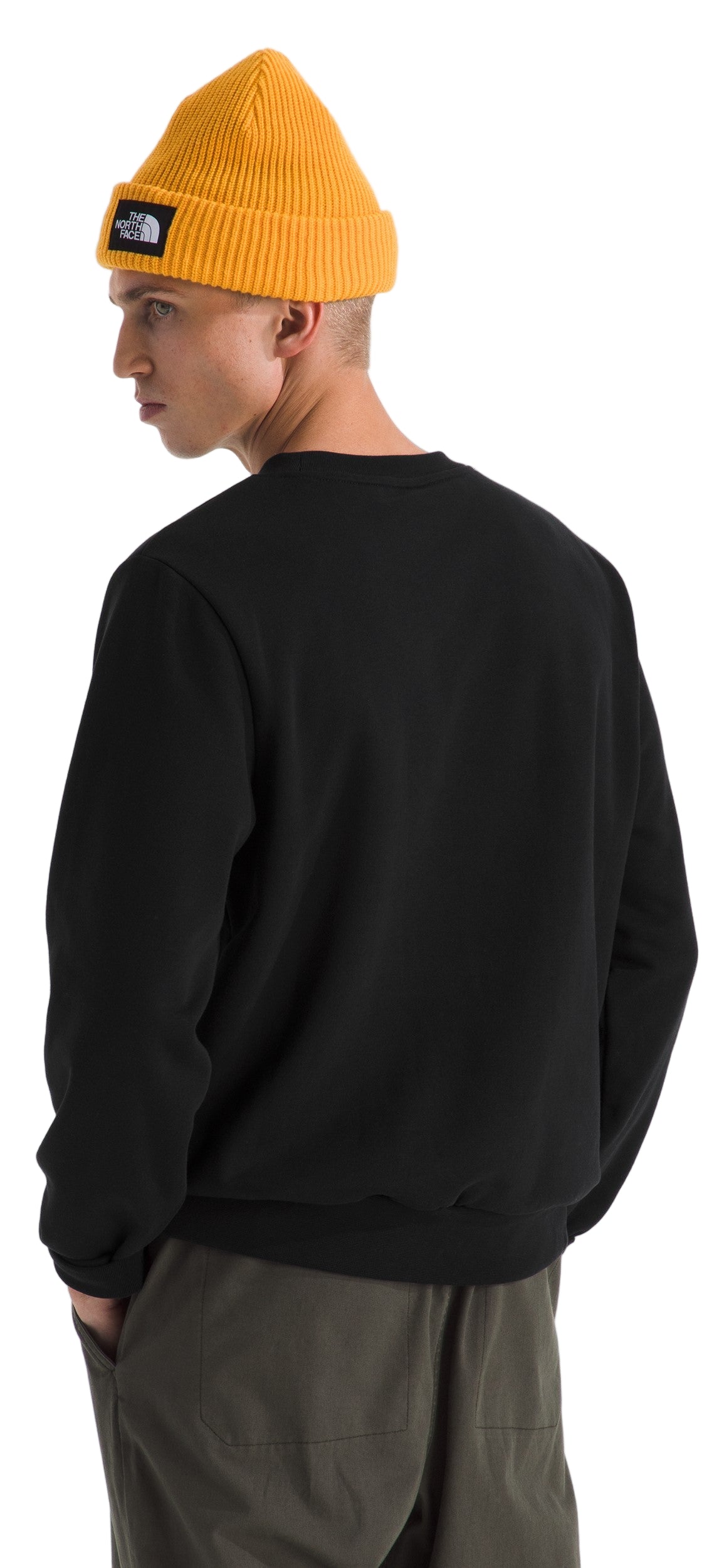 A person in a yellow beanie and black sweater.