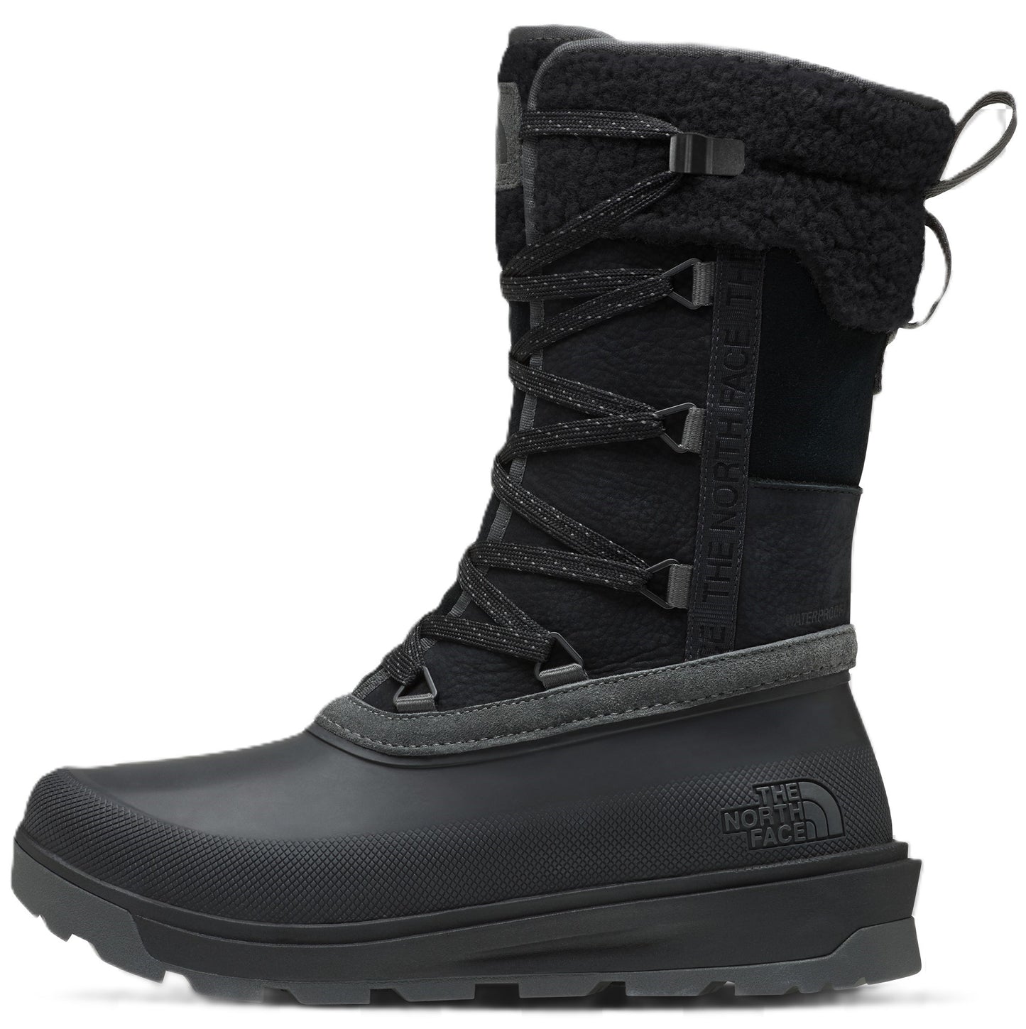 A black, mid-calf winter boot featuring a durable, rubberized shell at the base with a textured toe and thick, rugged outsole. The upper is constructed from black fabric with a lace-up front, a fuzzy fleece-lined collar, and a branded tab on the side.