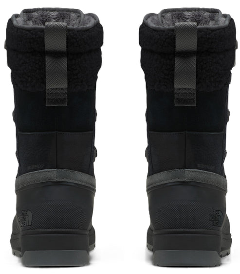 A pair of black, mid-calf winter boots viewed from the back, featuring a textured heel, a gray midsole, a pull tab at the collar, and a plush fleece lining.