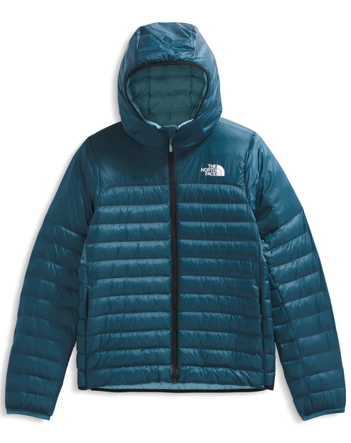 A hooded, zippered, teal quilted jacket with a white logo on the upper right side.