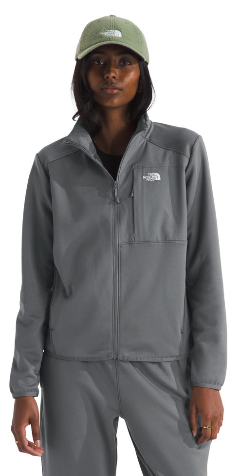 Person wearing a grey full-zip jacket with a breast pocket and a green cap.