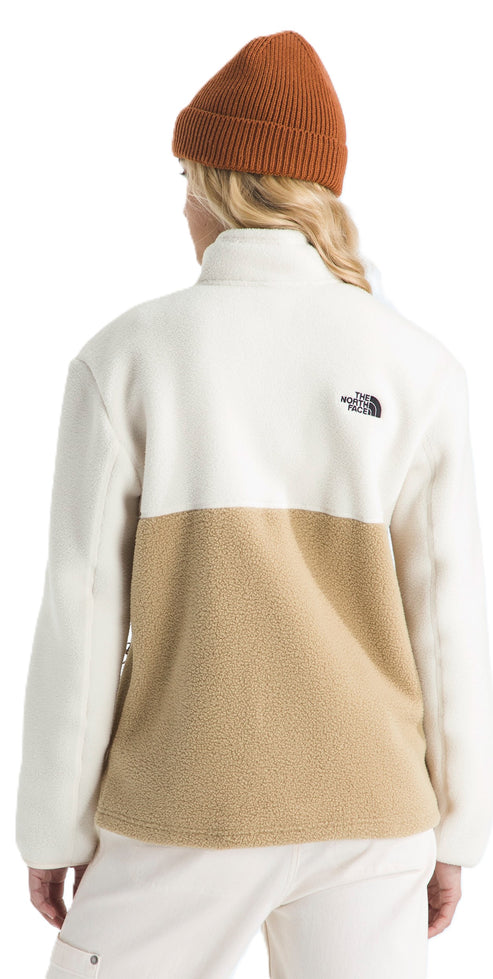 A woman wearing a tan beanie and a tan and white fleece pullover.