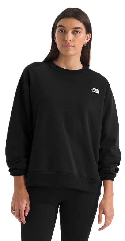 A woman in a black sweatshirt with a logo in the upper right.
