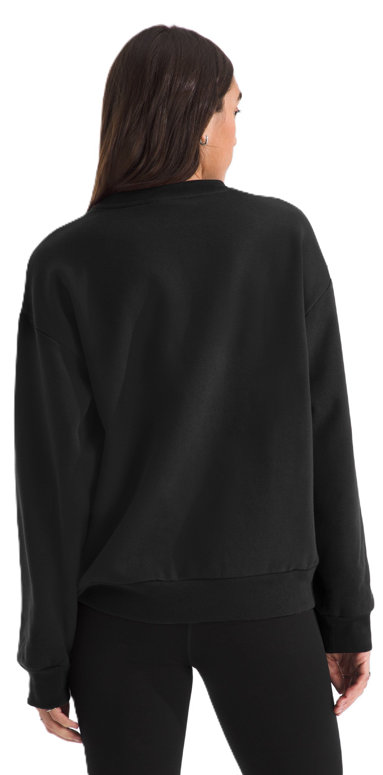 Person wearing a black long sleeve sweatshirt and leggings, showing the back of the garment.