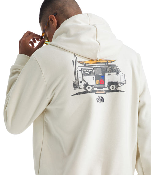 Person wearing a beige hoodie with a drawing of a van with a surfboard on top and The North Face logo.