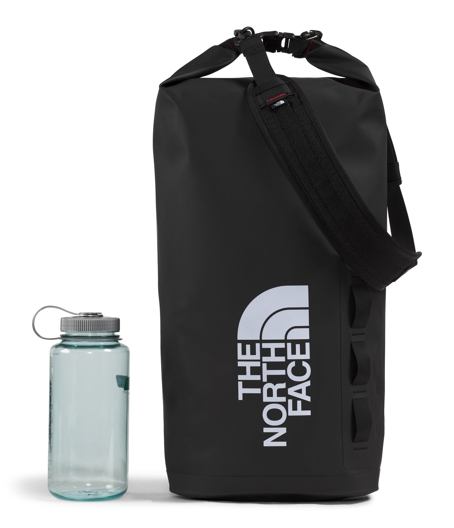 Black duffel bag with a white "THE NORTH FACE" text design, next to a water bottle.