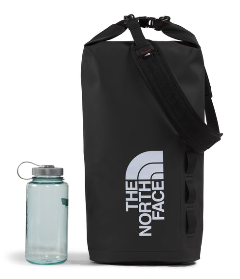 Black duffel bag with a white "THE NORTH FACE" text design, next to a water bottle.