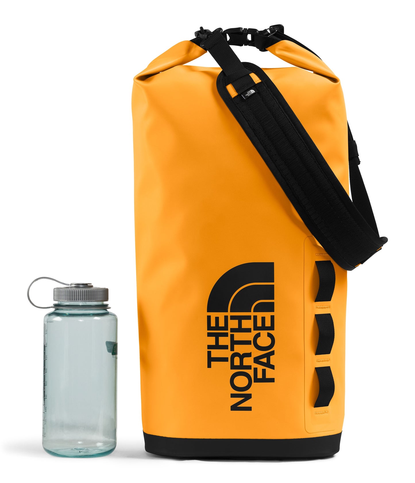 The North Face yellow duffel bag with a black strap and logo, next to a water bottle.