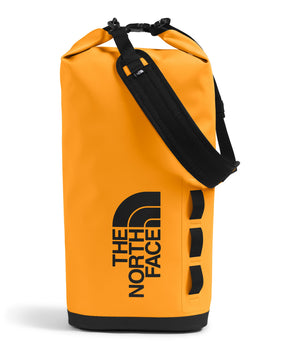 Tall, orange dry bag with black shoulder strap and The North Face logo.