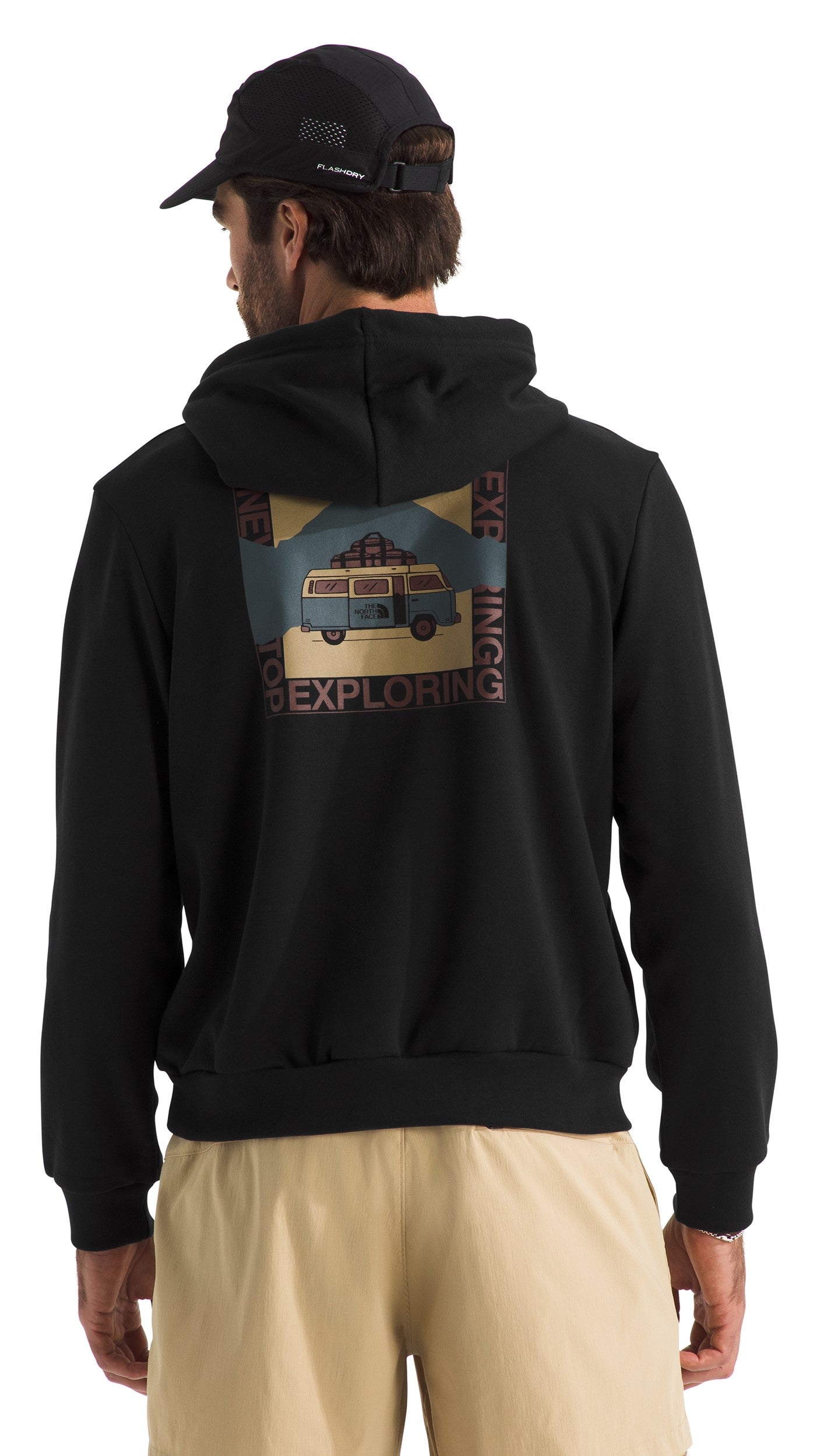 Man facing back wearing a black hoodie with a graphic of a van and nature scene, with the words "Exploring" and "Adventuring" surrounding the graphic.