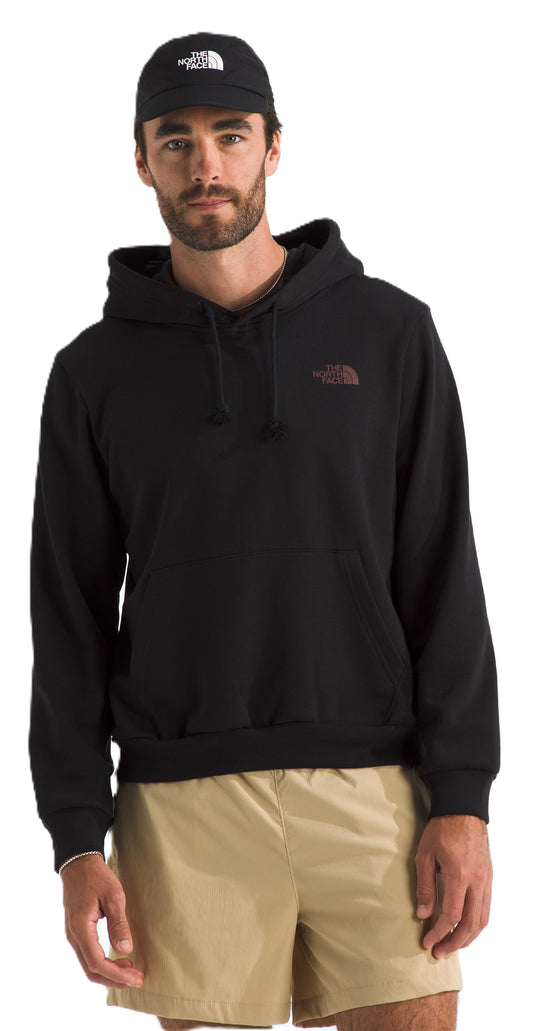 A man wearing a black hoodie and khaki shorts with a black cap.