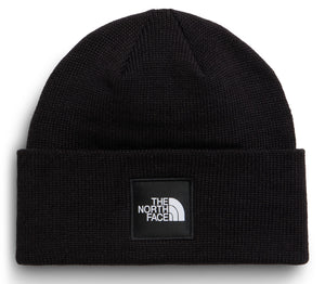 A black knitted beanie featuring a square patch on the front with the text "THE NORTH FACE" in white.