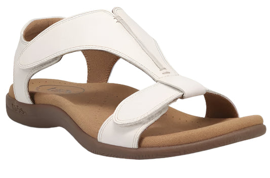 White sandal with velcro straps and a brown sole.