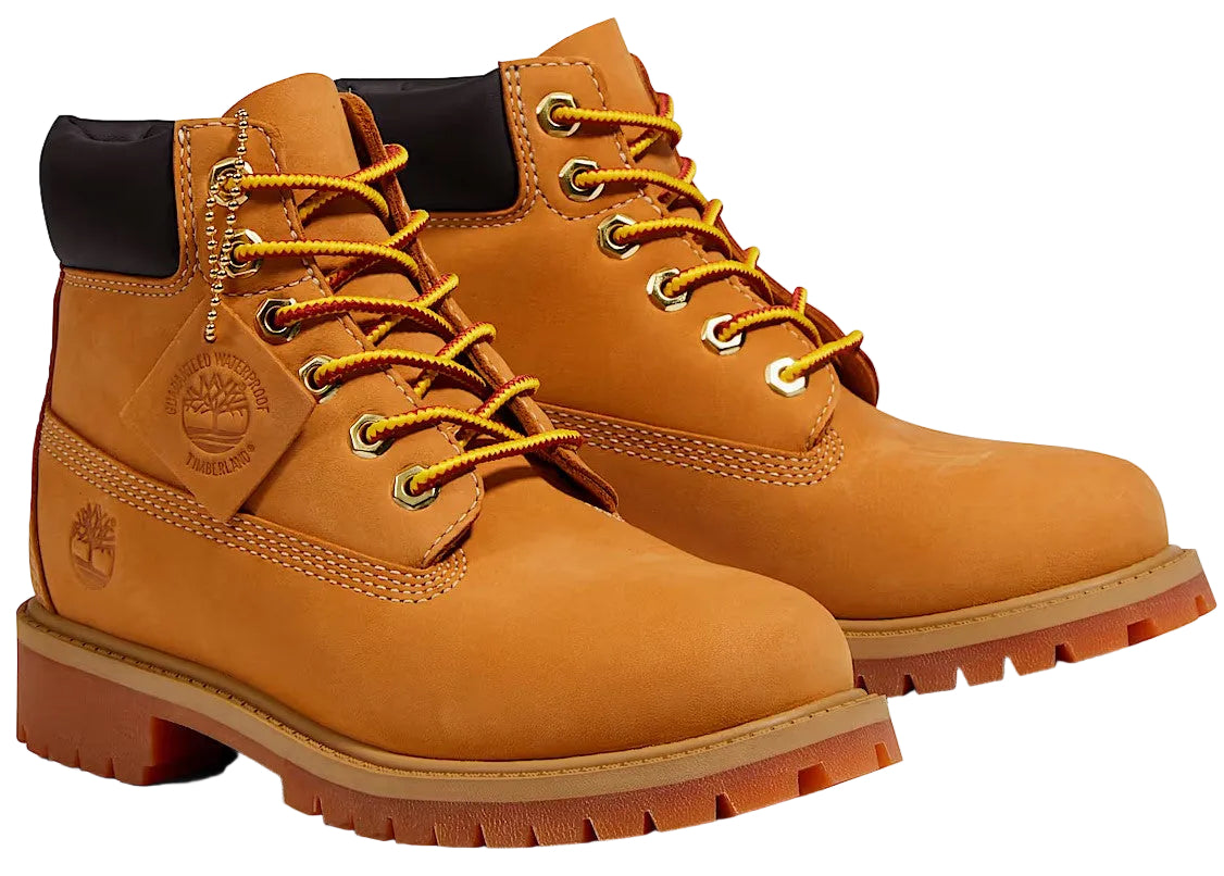 A pair of classic tan leather, waterproof lace-up work boots with black padded collars, metal eyelets, thick rubber lug outsoles, and an embossed tree logo on the side.