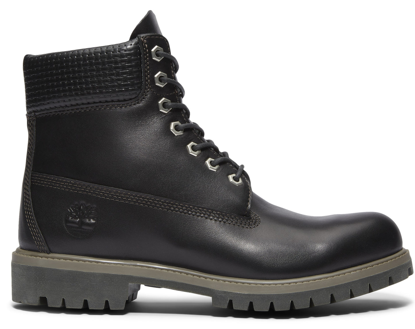 Black leather boot with textured ankle cuff, silver eyelets and thick grey sole.