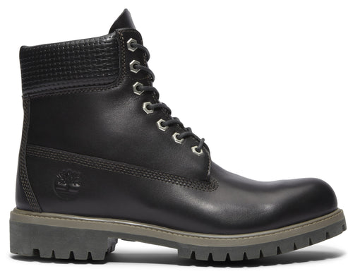 Black leather boot with textured ankle cuff, silver eyelets and thick grey sole.