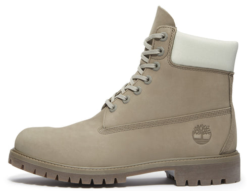 Beige leather work boot with off-white padded collar, lace-up closure, lug sole and embossed tree logo.