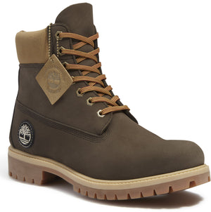 Dark brown work boot with tan padded collar and light brown sole with laces and logo.