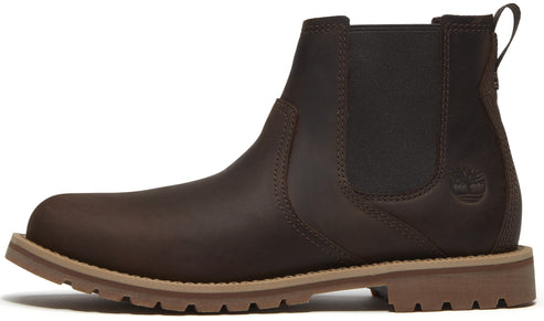 A dark brown leather Chelsea boot with elastic side panels, a pull tab at the heel, and a tan lugged rubber sole, viewed from the side.