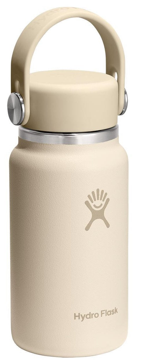 A light beige, wide-mouth insulated stainless steel water bottle with a matching screw-top lid that features a flexible carry handle, with the text Hydro Flask and a corresponding logo printed on the front.