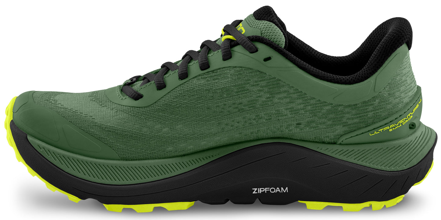Green running shoe with black midsole and neon yellow outsole.