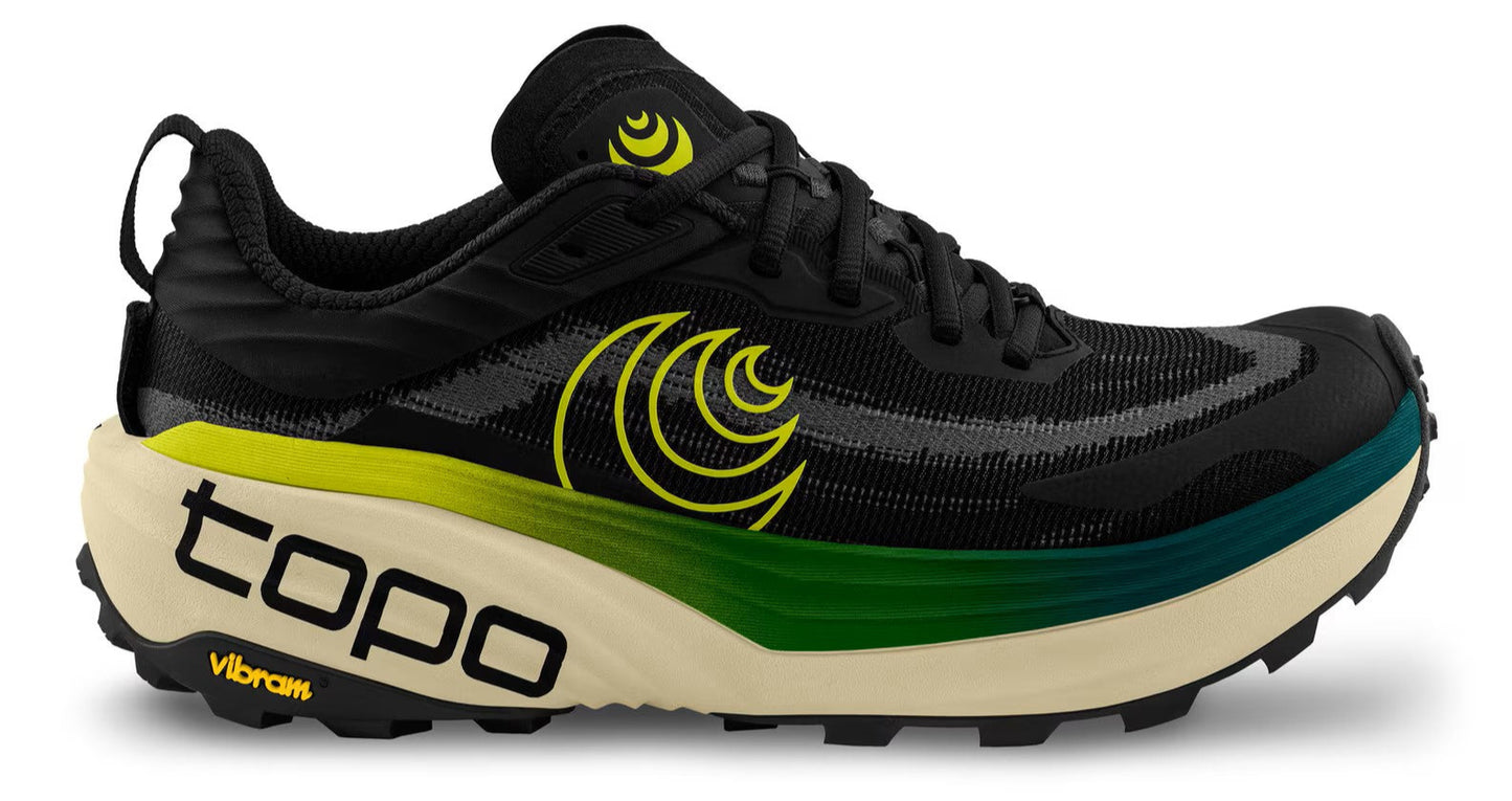 Black running shoe with yellow accents, 'topo' and 'Vibram' text on the cream-colored sole.