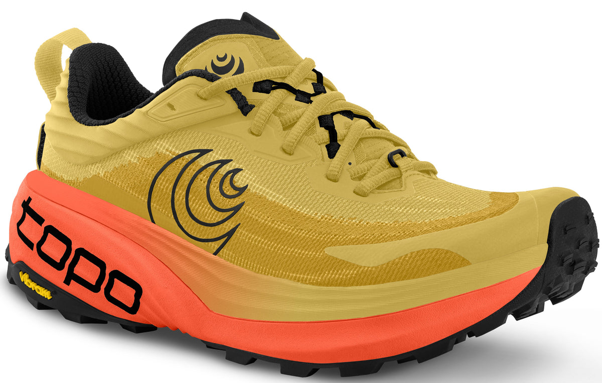 Yellow running shoe with orange sole and black vibram tread.