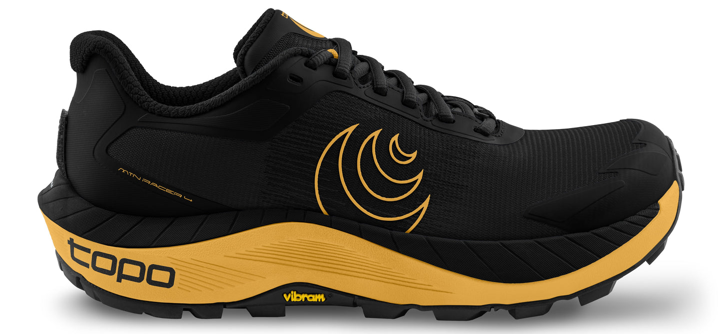 A running shoe in black and gold with the Topo logo on the side.