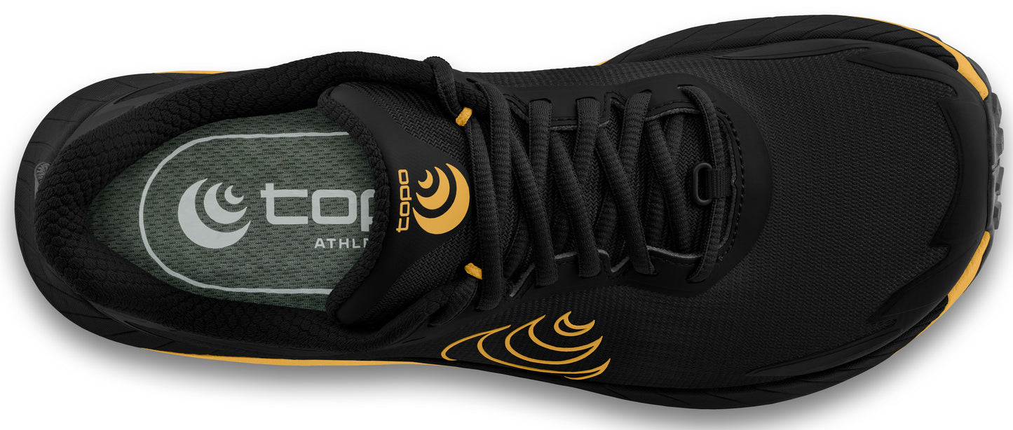 Top-down view of a running shoe with a black upper and gold accents, featuring a traditional lace-up closure and visible branding on the insole.