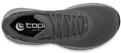A grey running shoe, showing the laces and insole with the text "topo athletic".