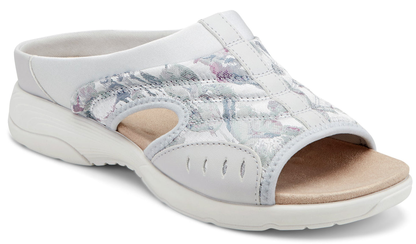 White slide sandal with floral patterned quilted design and open toe.