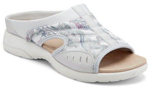 White slide sandal with floral patterned quilted design and open toe.