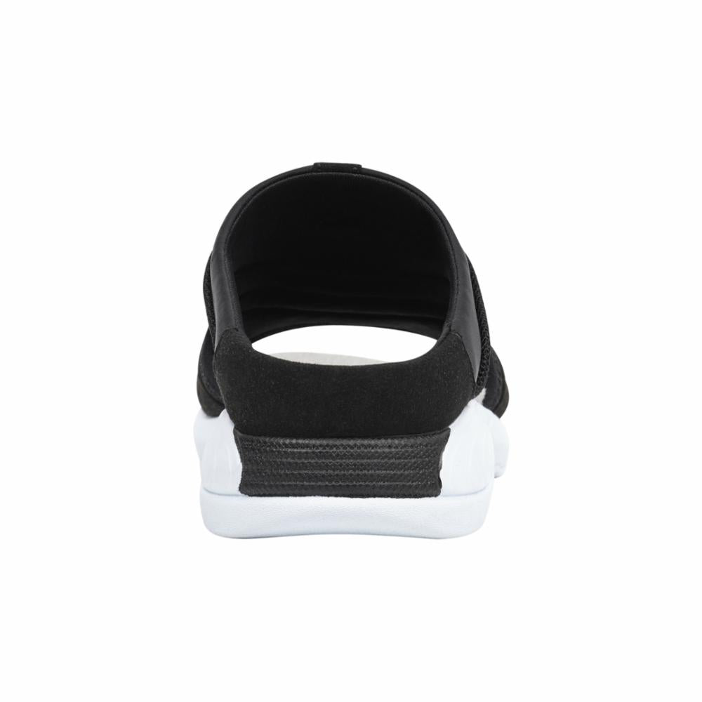 Black and white slip-on sandal with wide straps and a flat sole.