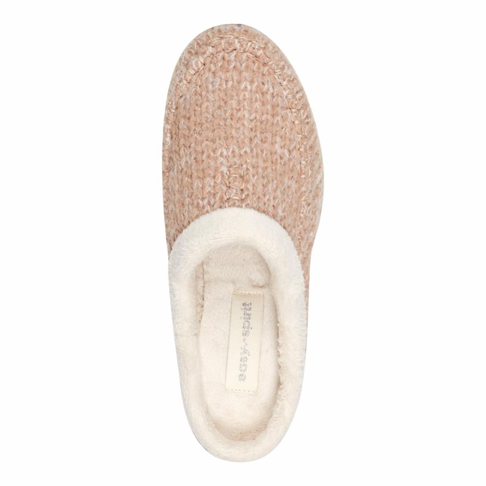 Beige slipper with white faux fur lining and “easy-spirit” brand tag.