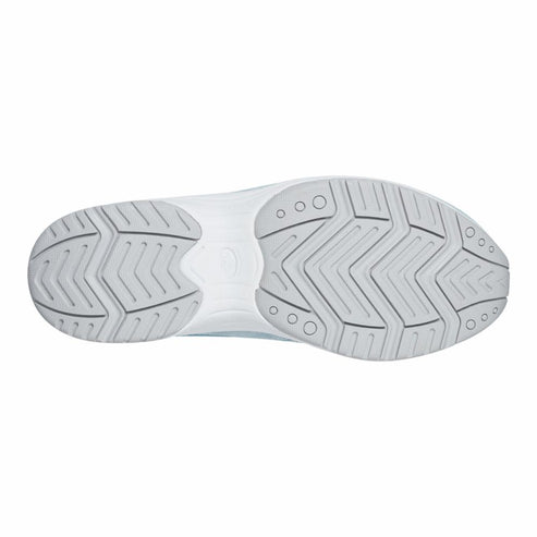 White sneaker sole with zig-zag tread pattern and small circular indentations.