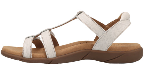 White strappy sandal with a flat, brown sole.