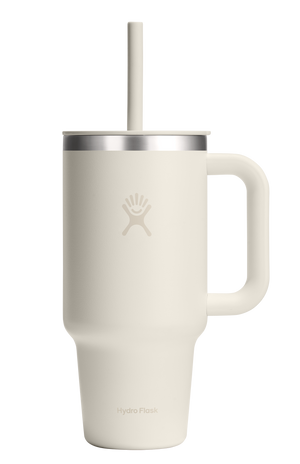 White mug with handle, silver lid, and straw.