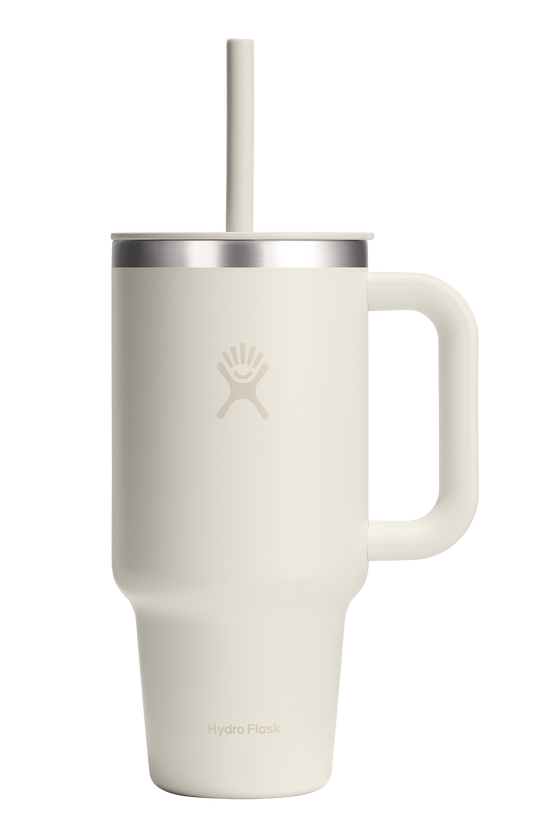 White mug with handle, silver lid, and straw.