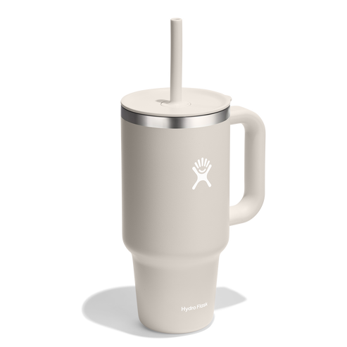White mug with handle and straw.