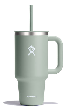 Light green insulated tumbler with a handle and straw, featuring a white logo.