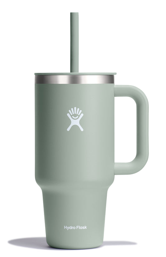 Light green insulated tumbler with a handle and straw, featuring a white logo.