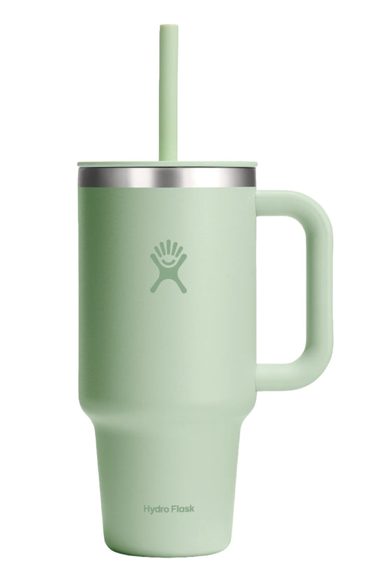 Mint green tumbler with handle, straw, and lid displaying a hand-shaped logo