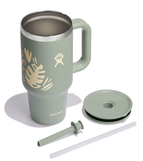 Green mug with a handle, straw, and straw lid.