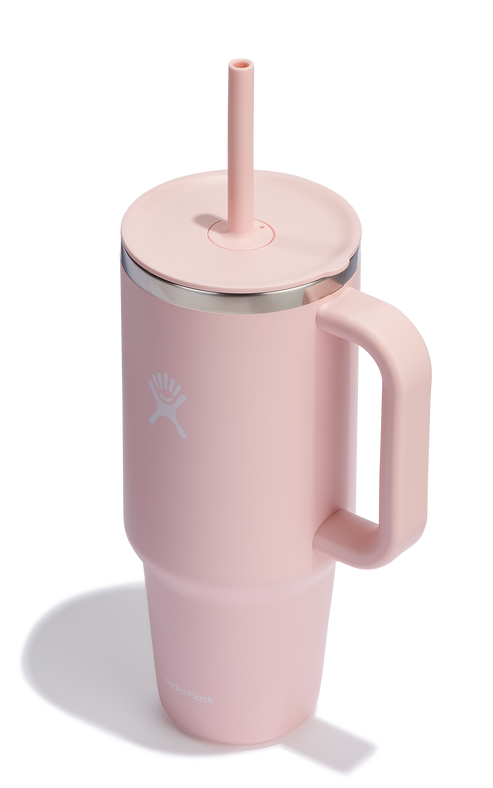 Pink insulated mug with a handle and straw lid.