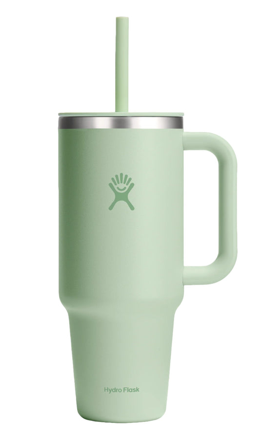 Green tumbler with a handle, lid, and straw; the text "Hydro Flask" is visible on the lower portion.