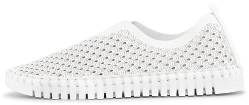 A white slip-on shoe with a perforated upper and a segmented sole.