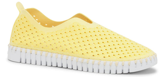 A yellow perforated slip-on shoe with a white, segmented sole.